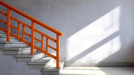 Modern staircase with orange railing, featuring clean lines and soft shadows, illuminated by natural light, creating a bright and inviting atmosphere in a minimalist space