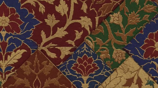 Patchwork of ornate colorful diamond patterns featuring floral and foliate motifs with metallic gold accents