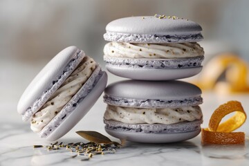 Stack of lavender macarons with cream filling and orange peel on a marble surface in soft light