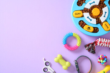Assorted pet toys and accessories on purple backdrop, featuring puzzle feeder, chew toys, grooming...