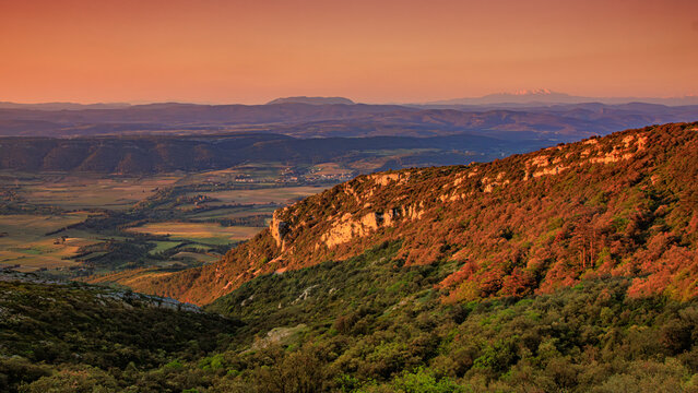 Early morning landscape from the top of Mount Alaric in the South of France. Garrigue, rocks, horizon, and the snow-capped Pyrenees.
