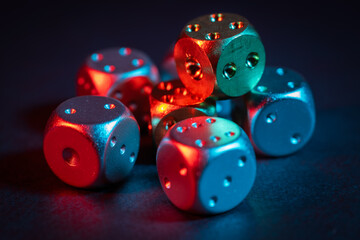 Colorful metallic dice view from above on black background