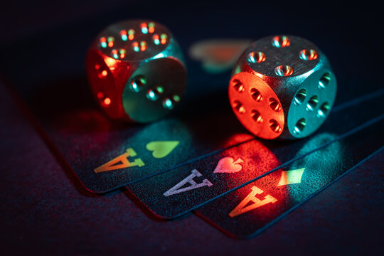 Casino games background with playing cards and dice for playing various games of chance on black table