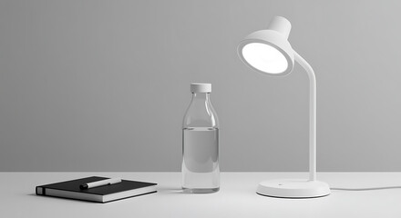 Minimalist white desk lamp illuminates a notebook and water bottle on a white surface