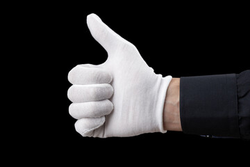 hand in white glove isolated on black background, showing like gesture. Concept of human gesture of approval, like, cool