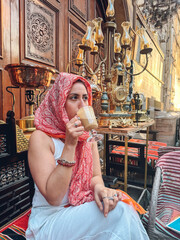 Tourist enjoying traditional coffee in khan el khalili, cairo