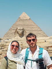 Tourists visiting the great pyramid of giza and sphinx in egypt