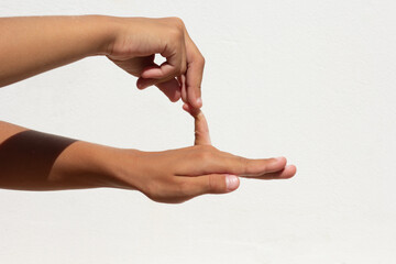 Child showing flexible little finger on white background