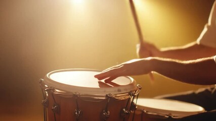 Close up drummer play drum with drumstick in stage light music instrument performance