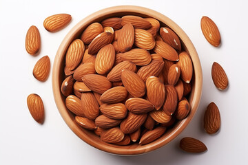 scattered whole almonds surrounding wooden bowl on white background