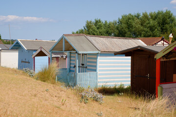 Old painted wooden beach hut in sand dunes