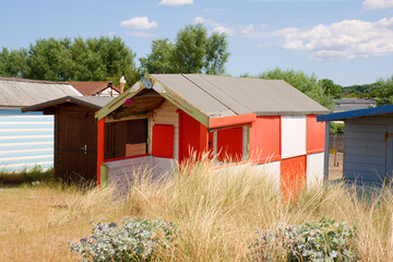 Old painted wooden beach hut in sand dunes