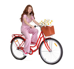 Smiling teenage girl riding bicycle with basket of flowers against white background