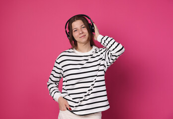 Teenage girl in headphones on crimson background