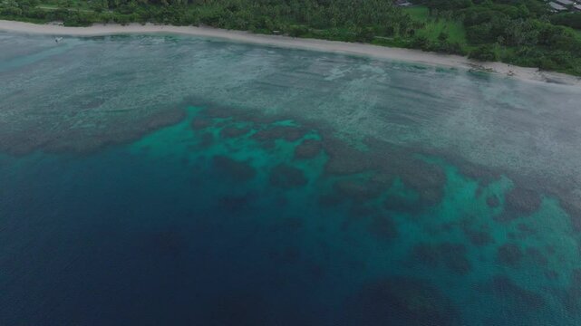 Underwater coral pattern and blue hues captured from aerial in Fiji waters