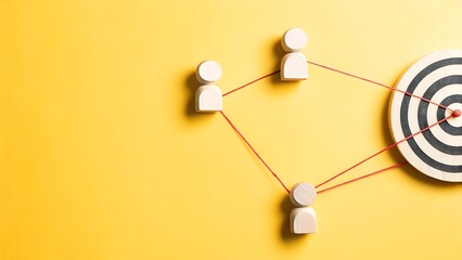 Achieving Shared Goal: Wooden Figures Connected to Target, Illustrating Connection, Collaboration, and Success on a Bright Yellow Backdrop.