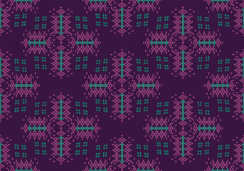 A vibrant textile pattern composed of pink, green, and teal geometric shapes on a deep purple base. The structured pixel design repeats evenly, evoking cultural and festive influences.