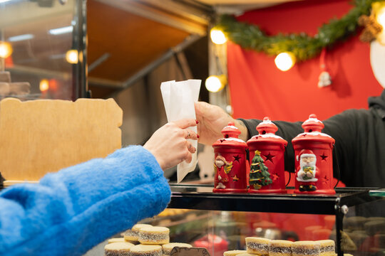 Women exchanging food at christmas market stall