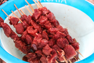 Raw Beef Skewers in Bowl