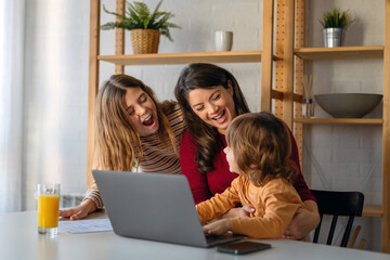 Moms can balance work and family.. Family is working on laptop and having fun together at home.