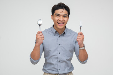 Excited young Asian man ready to eat