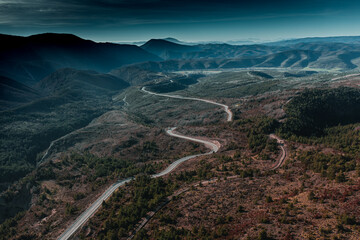 aerial view over andorran mountains with windy road