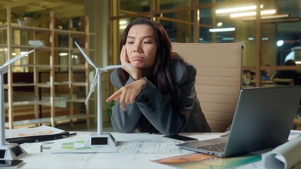 Sad tired business woman Asian girl businesswoman exhausted boring work wind turbine energy...