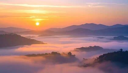 Obraz premium Breathtaking sunrise over misty mountains, revealing a serene and tranquil landscape filled with soft colors and natural beauty.