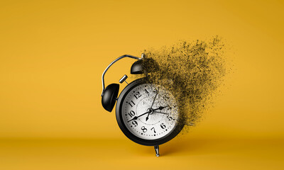 A black alarm clock dissolving on yellow background. Concept of effective time management and the importance of moments conveying time running out.