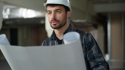 Caucasian man architect builder looking blueprint plan building construction male guy engineer...