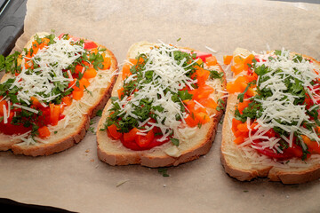 Close-up of tomato bruschetta on artisan bread slices with fresh sliced ​​tomatoes, parmesan...