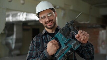 Man building industry repairman builder holding hammer drill repair work construction renovation...