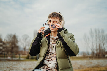 Young adult caucasian student smile and using smart phone to talk or take self portrait