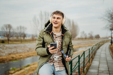 Young adult caucasian student smile and using smart phone to talk or take self portrait
