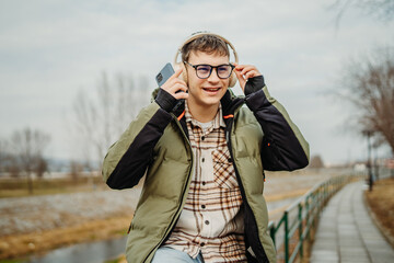 Young adult caucasian student smile and using smart phone to talk or take self portrait