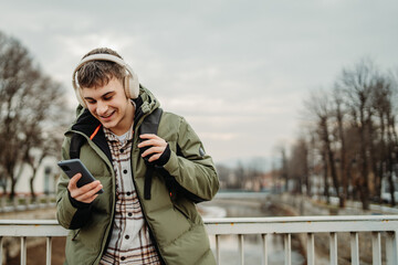 Young adult caucasian student smile and using smart phone to talk or take self portrait