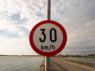 Speed limit sign 30 km/h on coastal road