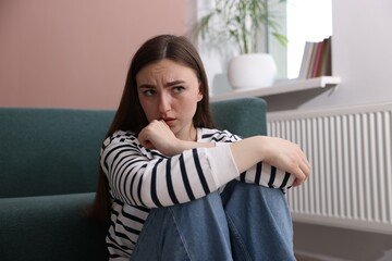 Worried woman suffering from paranoia at home