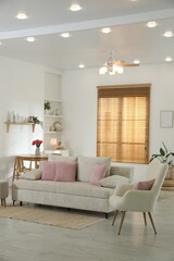 Comfortable sofa with cushions in room. Interior design