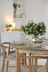 Bouquet of beautiful jasmine flowers on dining table indoors