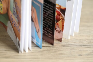 One open magazine on wooden table, closeup