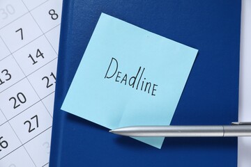 Sticky note with word Deadline, notebook, pen and calendar on table, top view