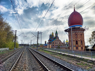 Kazan temple of all religions alongside railway tracks under a cloudy sky
