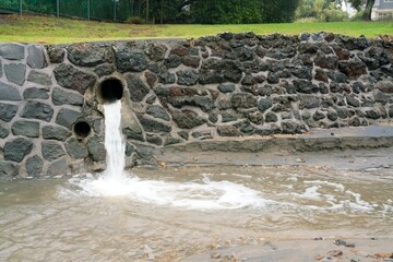 Water Emerging from Sewage Pipe During Stormy Weather