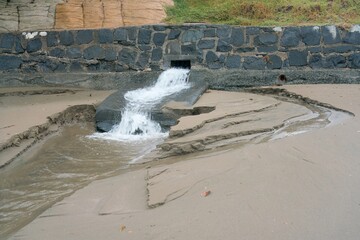 Water Emerging from Sewage Pipe During Stormy Weather