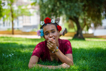 Beautiful young woman wearing flower crown, enjoying sunny day outdoors