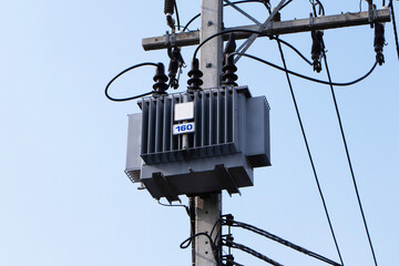 Transformers big size and electric wire. Electrical post. Technology on electric power. Blue sky...