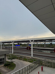 Bandung, Indonesia-December 28, 2024: A modern high-speed train at Tegalluar Station in Bandung under a vast sky at dusk.