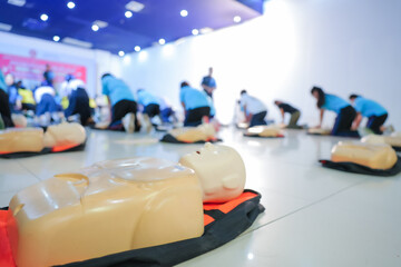 A person performs CPR chest compressions on a during a training session, highlighting essential...