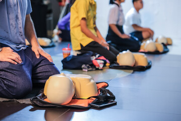A person performs CPR chest compressions on a during a training session, highlighting essential...